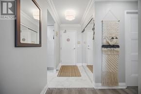 Mississauga (City Centre) condo for rent - A hallway with a rug and a brokerage sign.