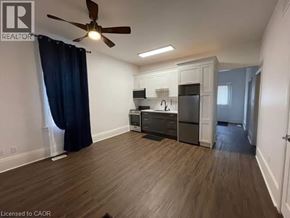 Kitchener apartment for rent - A well-lit, spacious kitchen area with wooden flooring and modern appliances.