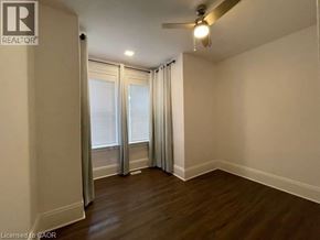 Kitchener apartment for rent - A room with a ceiling fan and sliding glass doors.