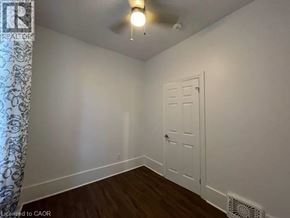 Kitchener apartment for rent - A room with a white door and a ceiling fan.