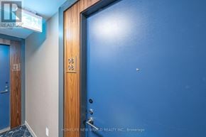 Toronto (Waterfront Communities) condo for rent - A blue wall with a door and a sign that says "REALTOR".