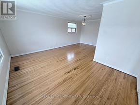 Toronto (Clairlea-Birchmount) apartment for rent - A room with wooden flooring and a window.