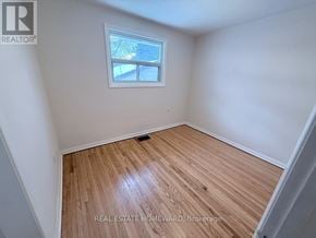 Toronto (Clairlea-Birchmount) apartment for rent - A room with a window and wooden flooring.