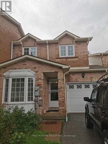 Mississauga (East Credit) townhouse for rent - A house with a brick facade and a white garage door.
