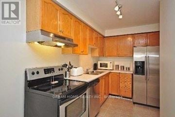 Mississauga (East Credit) townhouse for rent - A kitchen with wooden cabinets and stainless steel appliances.