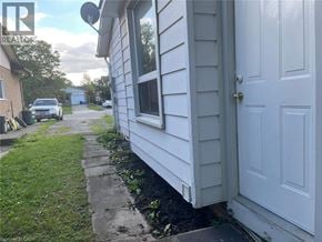 Welland apartment for rent - A white house with a door and a window is shown.