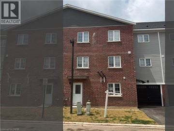 Welland townhouse for rent - A red brick house with a white door and a sign that says REALTOR.
