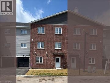 Welland townhouse for rent - A brick house with a garage is shown in the image.