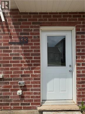Welland townhouse for rent - A white door is on the brick house.
