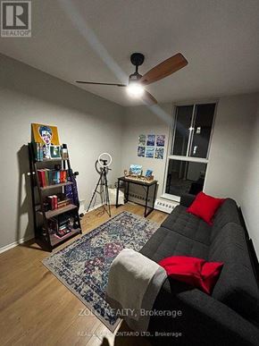 Hamilton (Ainslie Wood) condo for rent - A living room with a grey couch, a rug, a bookshelf, and a ceiling fan.