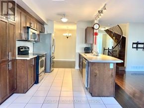 Ottawa townhouse for rent - A kitchen with wooden cabinets and a white refrigerator.