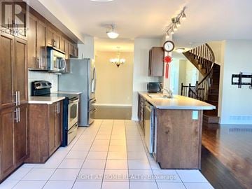 Ottawa townhouse for rent - A kitchen with wooden cabinets and a white refrigerator.