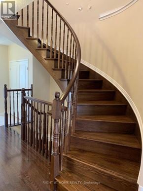 Ottawa townhouse for rent - A wooden staircase with a metal railing.
