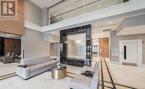 Niagara Falls (Hospital) condo for rent - A modern living room with a marble fountain and a large mirror.