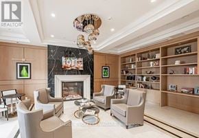 Niagara Falls (Hospital) condo for rent - A living room with a fireplace and a bookshelf.