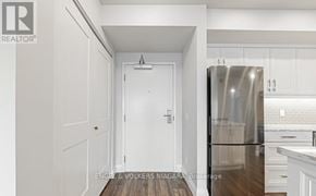 Niagara Falls (Hospital) condo for rent - A white door is in a hallway with a brokerage logo on the bottom left.