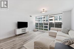 Toronto (Waterfront Communities) condo for rent - A living room with a television and a couch.