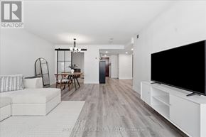 Toronto (Waterfront Communities) condo for rent - A living room with a white couch and a television on a stand.