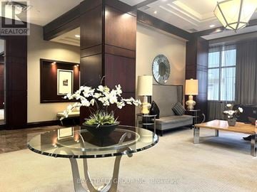 Toronto (Bay Street Corridor) condo for rent - A living room with a glass table and a sofa.