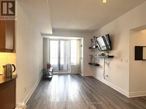 Toronto (Bay Street Corridor) condo for rent - A living room with a flat screen TV mounted on the wall.