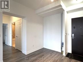 Toronto (Bay Street Corridor) condo for rent - A room with a black door and a pair of shoes on the floor.