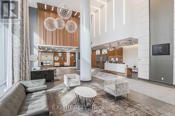 Toronto (Henry Farm) condo for rent - A modern living room with a grey sofa and a white coffee table.
