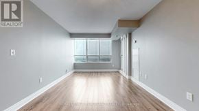 Toronto (Bendale) condo for rent - A spacious room with wooden flooring and a large window.