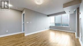 Toronto (Bendale) condo for rent - A spacious room with wooden flooring and a large window.