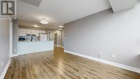 Toronto (Bendale) condo for rent - A spacious room with wooden flooring and white walls.