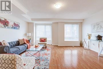 Oshawa (Eastdale) townhouse for rent - A living room with a blue couch and a coffee table.