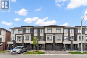 Oshawa (Eastdale) townhouse for rent - A row of townhouses with a silver minivan parked in front of the first one.