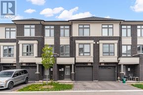 Oshawa (Eastdale) townhouse for rent - A row of townhouses with a car parked in front.
