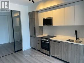 Toronto (Centennial Scarborough) condo for rent - A modern kitchen with wooden cabinets and stainless steel appliances.