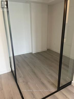 Toronto (Centennial Scarborough) condo for rent - A room with a glass door and wooden flooring.