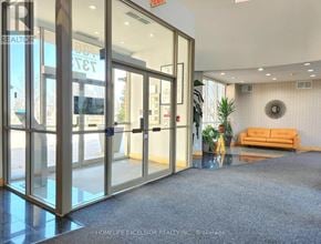 Markham (Milliken Mills East) condo for rent - The image shows the interior of a realtor's office with glass doors and a carpeted floor.