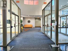 Markham (Milliken Mills East) condo for rent - A hallway with glass doors and exit signs above them.