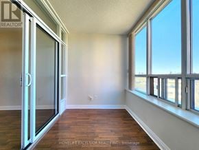 Markham (Milliken Mills East) condo for rent - A room with a sliding glass door and wooden flooring.