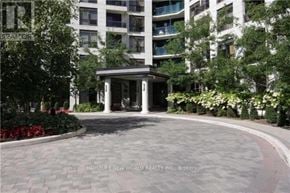 Richmond Hill (Harding) condo for rent - A building entrance with a circular driveway and a small pavilion.