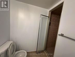 Richmond Hill (Harding) condo for rent - A bathroom with a toilet, a glass shower door, and a towel rack.