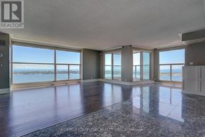 Toronto (Waterfront Communities) condo for rent - A spacious room with a view of the water through large windows.