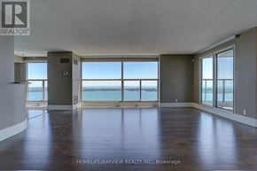 Toronto (Waterfront Communities) condo for rent - A spacious room with large windows overlooking the water.