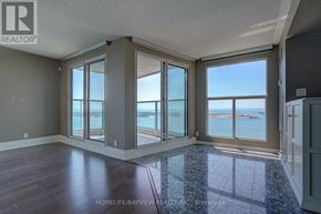 Toronto (Waterfront Communities) condo for rent - A room with a view of the ocean through large windows.