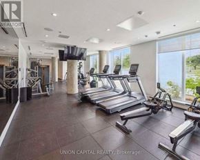 Toronto (Downsview-Roding-Cfb) condo for rent - A gym with treadmills, weights, and a television is shown.