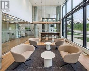 Toronto (Downsview-Roding-Cfb) condo for rent - A modern waiting area with beige chairs and a glass wall.