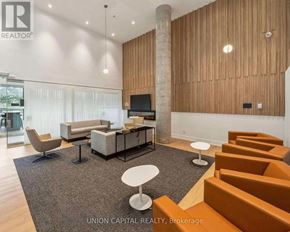 Toronto (Downsview-Roding-Cfb) condo for rent - A living room with a grey carpet and orange chairs.