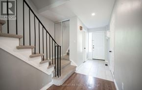 Milton (Dp Dorset Park) townhouse for rent - A hallway with a staircase and a door at the end.
