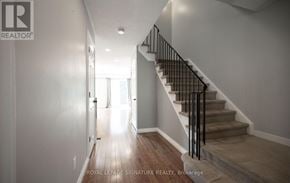 Milton (Dp Dorset Park) townhouse for rent - A hallway with a staircase and a doorway leading to another room.