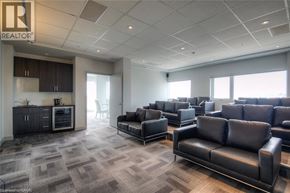 Kitchener condo for rent - A spacious waiting room with black leather couches and a carpeted floor.