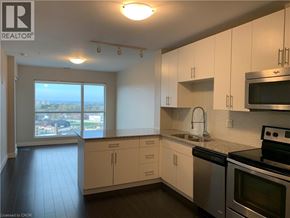 Kitchener condo for rent - A kitchen with white cabinets and a stainless steel oven.
