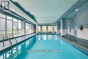 Toronto (Bendale) condo for rent - A large indoor swimming pool with a glass wall on one side.
